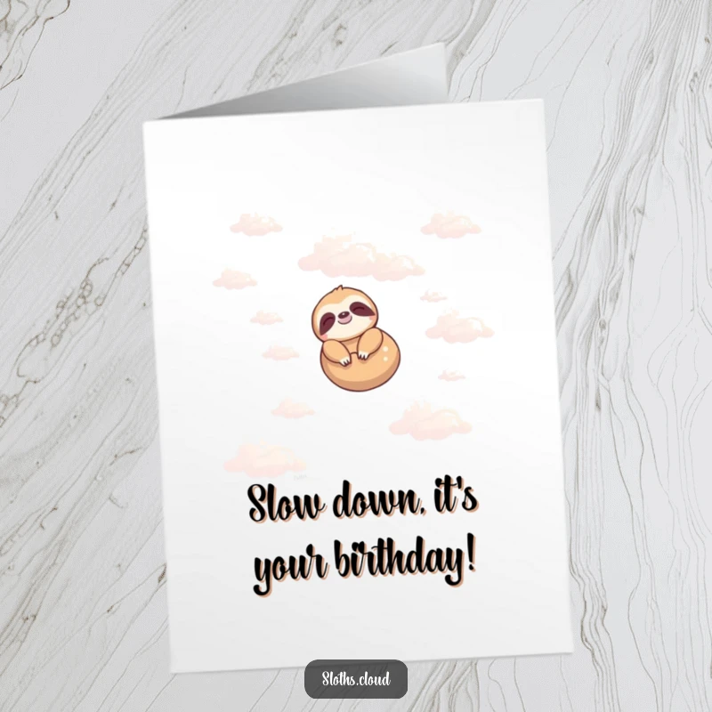 Funny Free Printable Birthday Card: A happy sloth peacefully floats among fluffy clouds, ready to deliver birthday cheer.